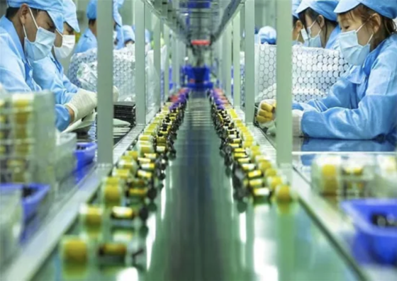 People working in a large vape factory